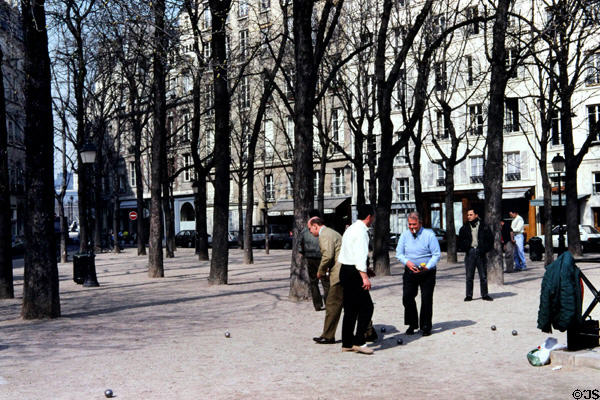 Men playing game of boules on triangular Place Dauphine on western tip of Isle de la Cité. Paris, France.