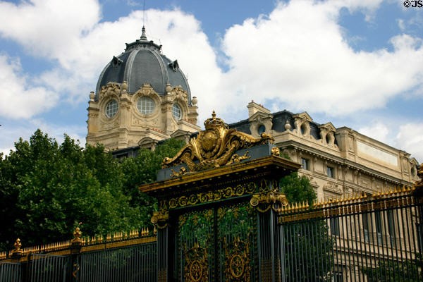 Dome of Court of Commerce seen over gate of Palais de Justice. Paris, France.