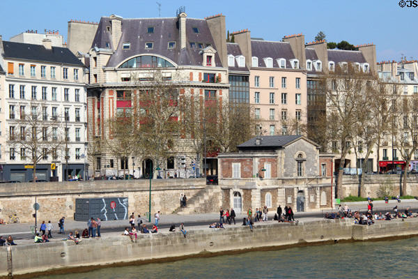 Seine riverfront buildings along Quai des Célestins opposite Île St Louis. Paris, France.