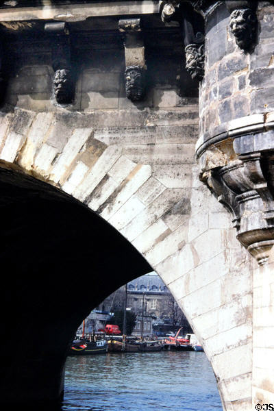 Arch of Pont Neuf over River Seine. Paris, France.