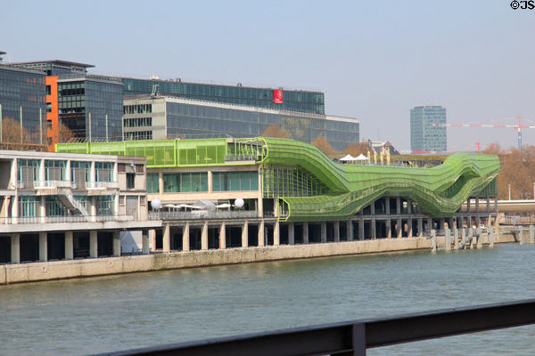 Buildings along Quai d'Austerlitz with green tubing facade on River Seine. Paris, France.