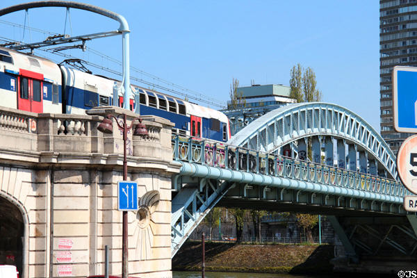 Commuter train crosses Pont Rouelle over Seine. Paris, France.