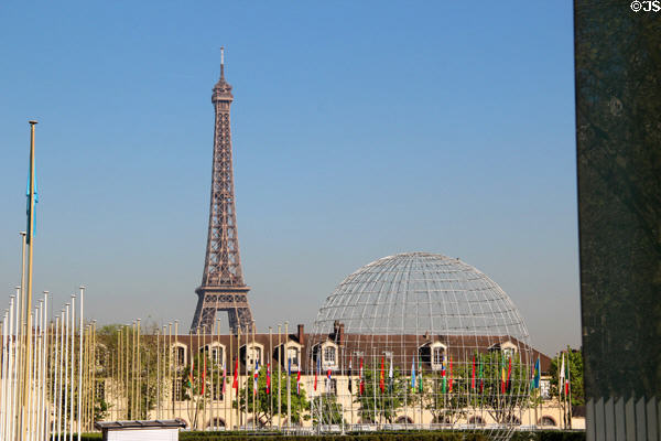 Eiffel Tower plus flag poles & wire globe seen from UNESCO Headquarters (1958). Paris, France.