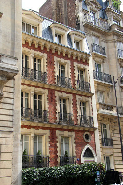 Residential building in brick with white quoins in 16th arrondissement. Paris, France.