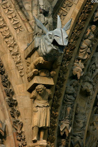 Rhinoceros supported by hunchback on Cathedral. Reims, France.