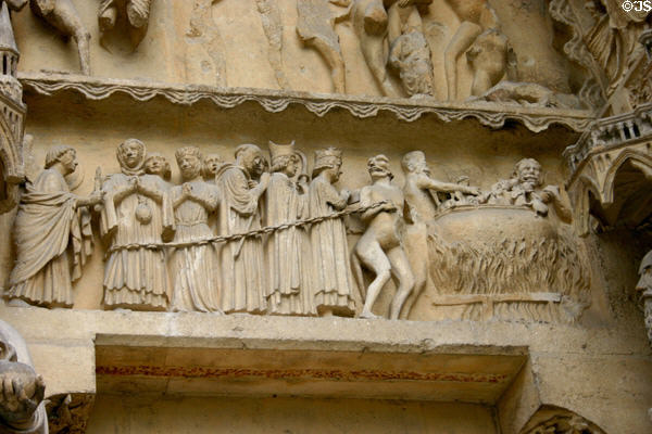 Bishops, rich & kings being thrown into burning vats of hell in Last Judgment scene on Cathedral. Reims, France.