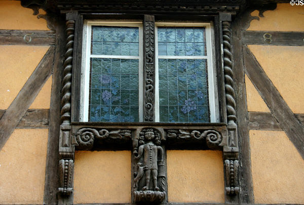 Carved window frame (c1680s) on half-timbered house. Riquewihr, France.