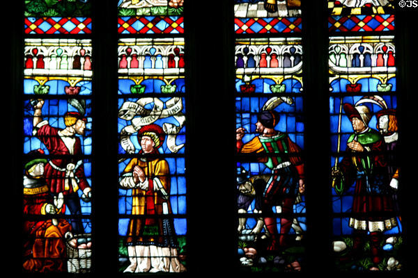 South transept stained glass windows of St. Stephen's Cathedral with figures in Medieval dress. Sens, France.