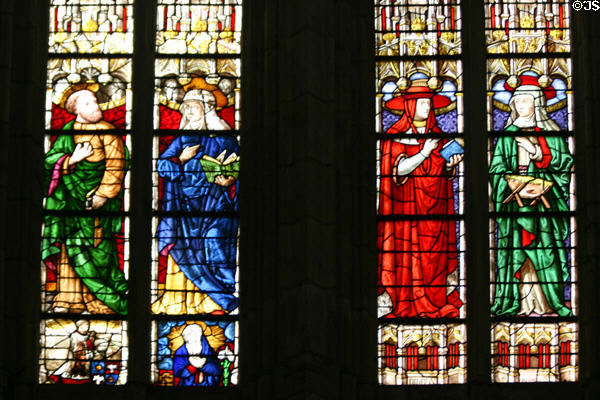 Stained glass window of St. Stephen's Cathedral with robed people. Sens, France.