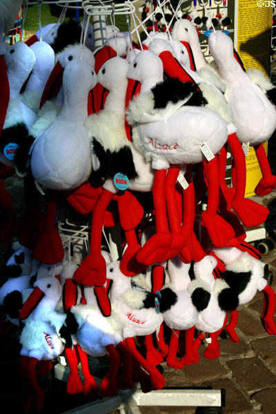 Plush stuffed toy storks on rack in Alsace. France.