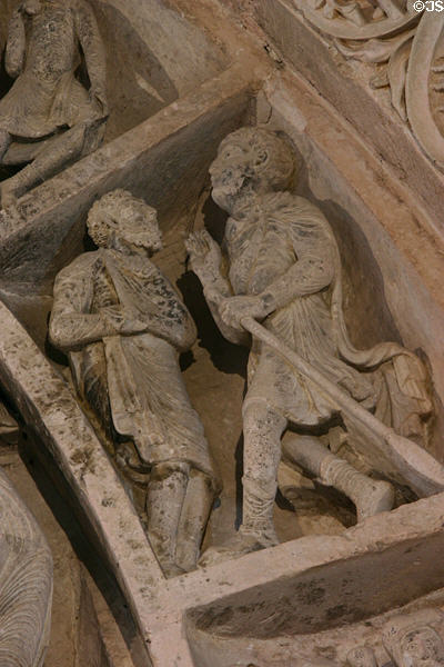 Narthex tympanum detail of two men at Basilique Ste-Madeleine. Vézelay, France.