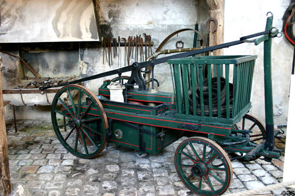 Fire pump carriage in coach collection at Vaux-le-Vicomte chateau. Melun, France.