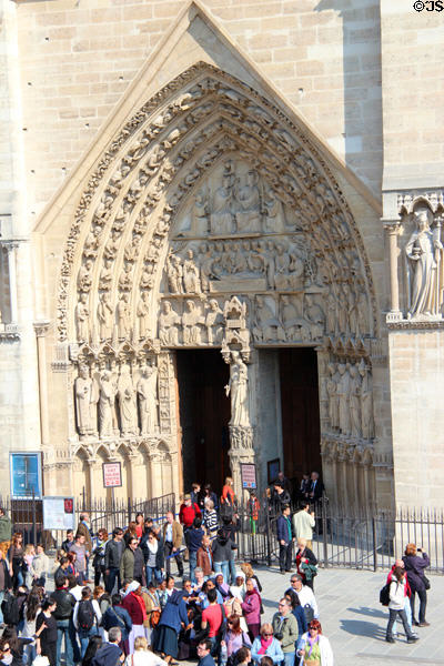 Left Gothic portal of Notre Dame Cathedral. Paris, France.