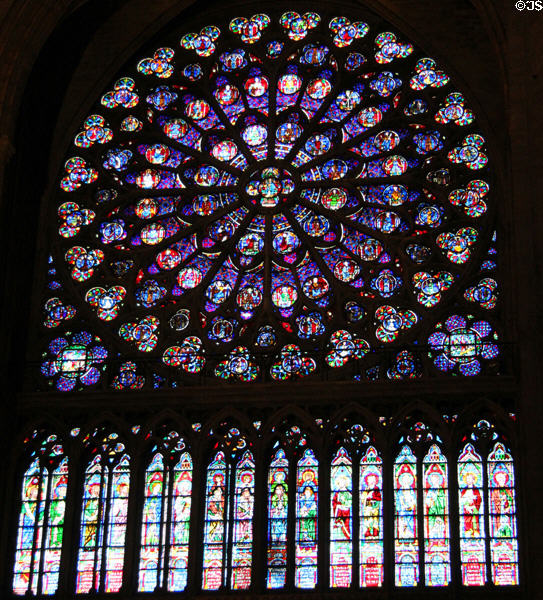 Rose window of Christ enthroned circled by apostles, saints & angels over vertical windows of saints & biblical figures in south transept of Notre Dame Cathedral. Paris, France.