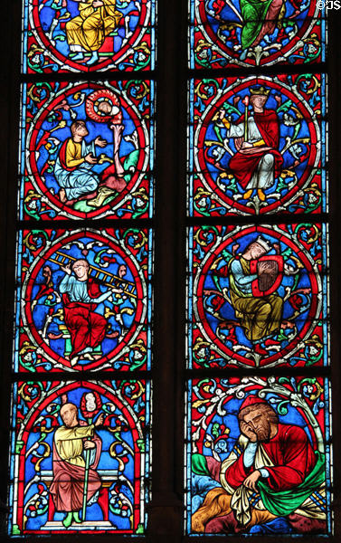 Robed worshipers stained glass window in Notre Dame Cathedral. Paris, France.