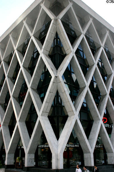Building with external crosshatched supporting structure on La Défense Esplanade. Paris, France.