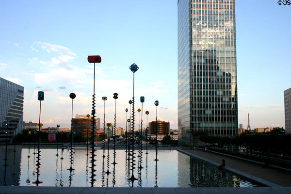 Initiale tower (1966) over Takis basin with signal sculpture at La Défense. Paris, France. Architect: .Jean de Mailly & Jacques Depussé.