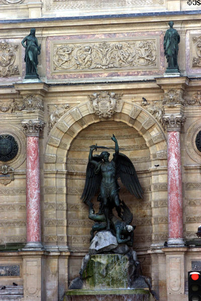 St-Michel Fountain in triumphal arch niche wherein earlier plans designated for sculpture of Napoleon I. Paris, France.
