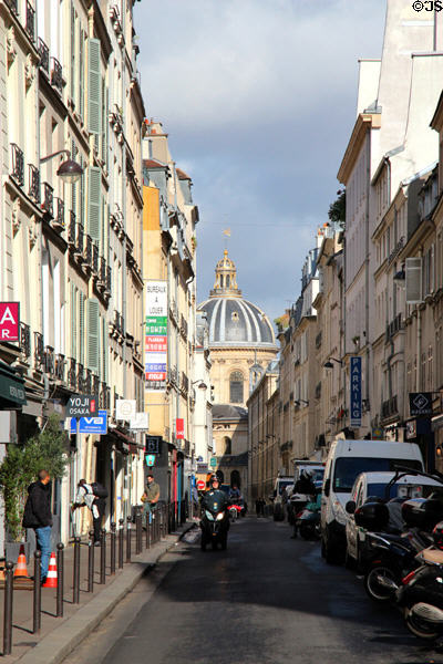 Rue Mazarine in Latin Quarter with domed Institute de France at end. Paris, France.
