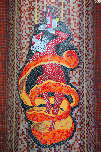 Mosaic sign of bar server wrapped in snake-like orange peel on rue de Seine in Latin Quarter. Paris, France.