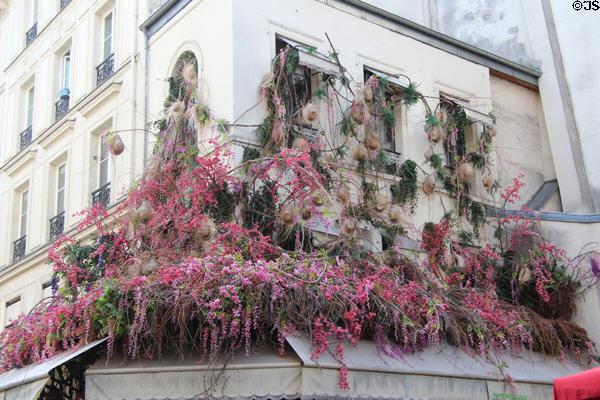 Hotel decorated with floral hangings on Rue de Buci in Latin Quarter. Paris, France.