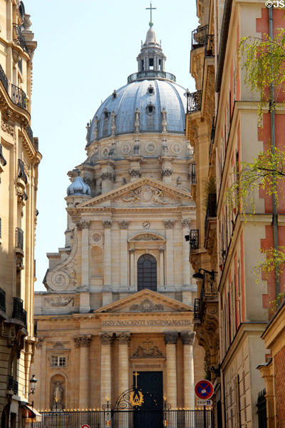 Baroque scroll & facade of Val-de-Grâce church seen from approaching street. Paris, France.