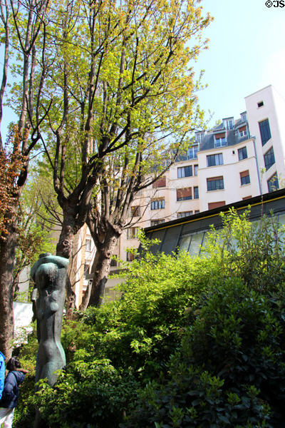 Art Deco building (1932) (102 rue d'Assas) over sculpture garden of Zadkine Museum. Paris, France.