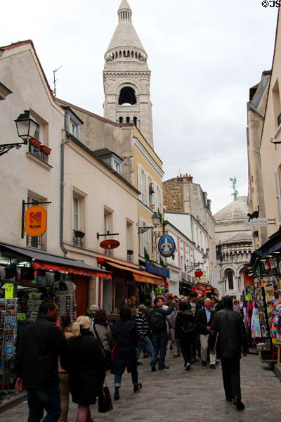 Rue Norvins with Basilica of the Sacred Heart of Paris bell tower beyond atop Montmartre. Paris, France.