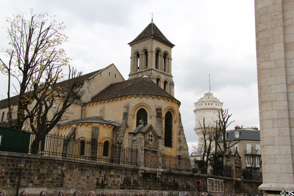 Apse end of Paroisse Saint-Pierre de Montmartre (12thC) church with Montmartre water tower beyond. Paris, France.