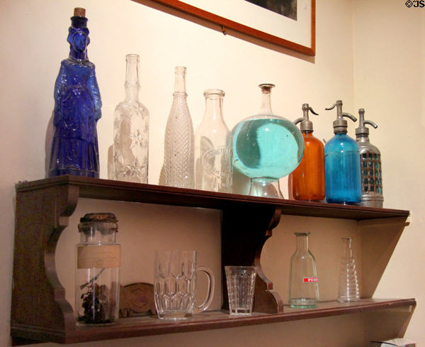Antique liquor bottles & glassware at Montmartre Museum. Paris, France.