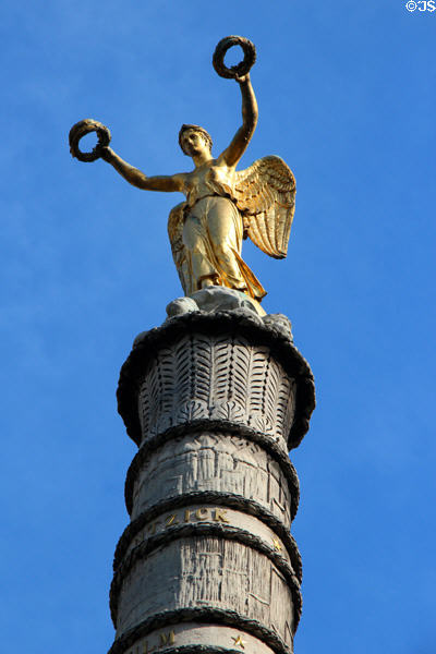 Winged victory statue over engraved palm leaves atop Fontaine du Palmier (1806) in Place du Châtelet. Paris, France.