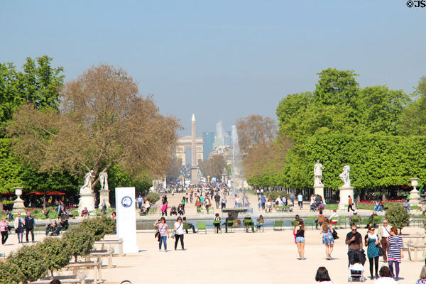 Sculptures surround Grand basin in Tuileries Garden with Obelisk & Arc du Triomphe beyond. Paris, France.