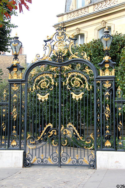 Gilded wrought iron gate at 19 Champs Elysees. Paris, France.