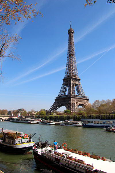 Eiffel Tower over Seine house boats. Paris, France.