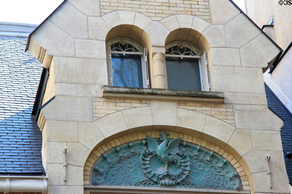 House with rooster sculpture in archway in 16th Arr. Paris, France.