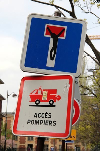 Dead-end street sign appended with crucified figure. Paris, France.