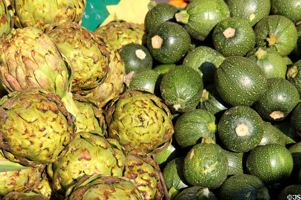 Artichokes & green melons in food stall. Paris, France.