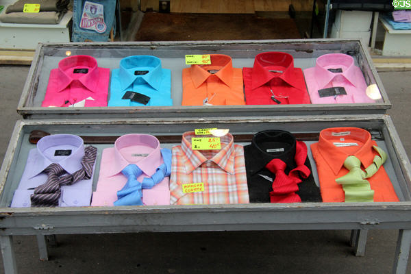 Brightly colored shirt & ties displayed in shop. Paris, France.