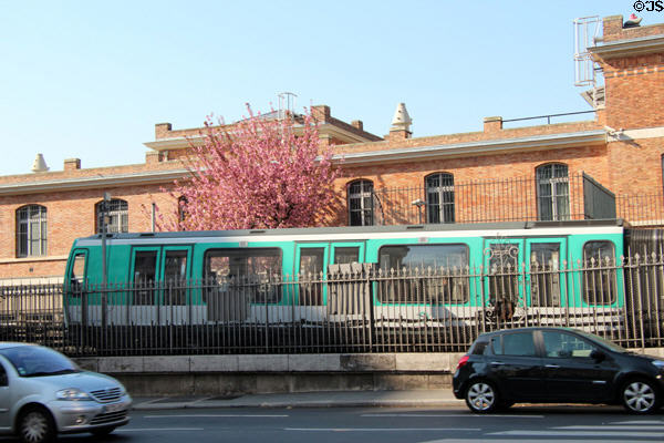 RATP metro train beside roadway. Paris, France.