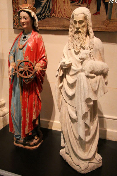 Ste Catherine of Alexandria wood carving (14thC) from Burgos, Spain & stone St John the Baptist (14thC) from Bourgogne, France at Museum of Decorative Arts. Paris, France.