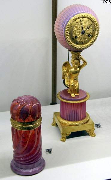 Opaline glass box & clock with gilded bronze supporting cupid at Museum of Decorative Arts. Paris, France.