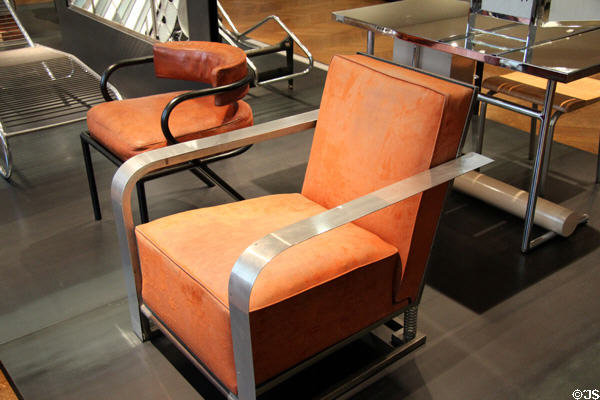 Armchairs (l) office chair with black tubular arms (1927) by René Herbst & (r) art deco chair with aluminum arms (1929) by Charlotte Alix & Louis Sognot at Museum of Decorative Arts. Paris, France.