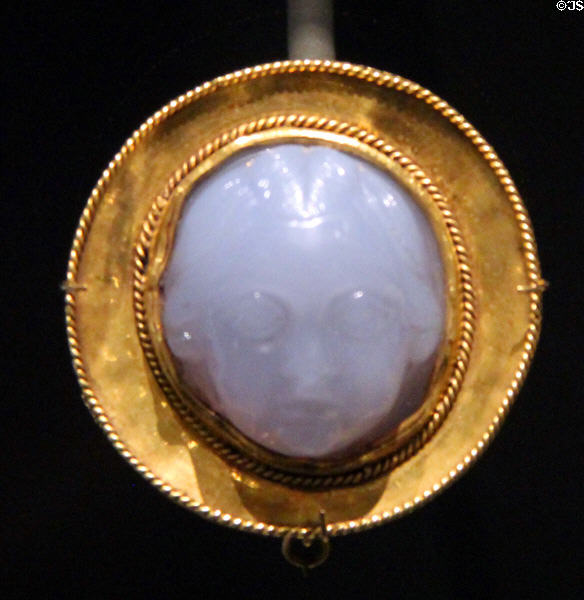 Stone cameo of child's face (2ndC) from Rome mounted in gold (early 15thC) in France at Cluny Museum. Paris, France.