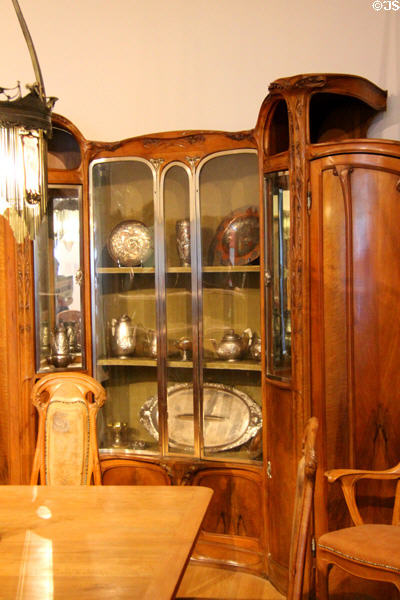 Guimard dining room vitrine (c1909) by Hector Guimard displaying metalware by Henri Husson at Petit Palace Museum. Paris, France.