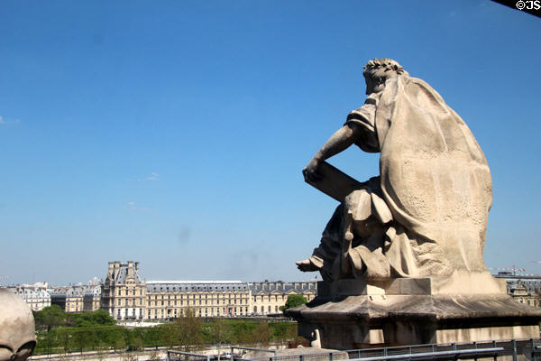 Statues atop Musée d'Orsay with Louvre beyond. Paris, France.