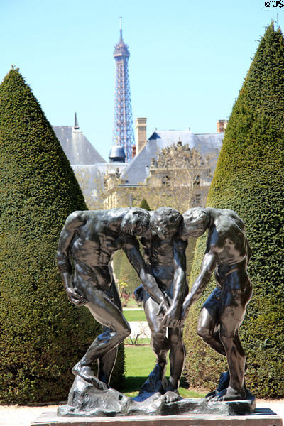 Three shades bronze sculpture (1902-4) by Auguste Rodin with Eiffel Tower beyond at Rodin Museum Garden. Paris, France.