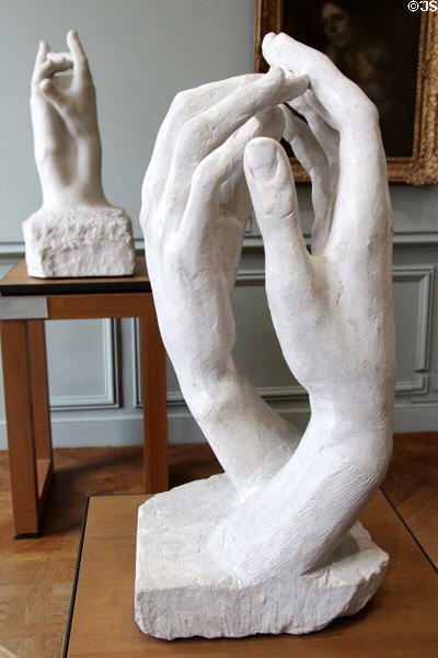 Sculpted hands: (front) stone The Cathedral (1908) & (rear) marble The Secret (1909) by Auguste Rodin at Rodin Museum. Paris, France.