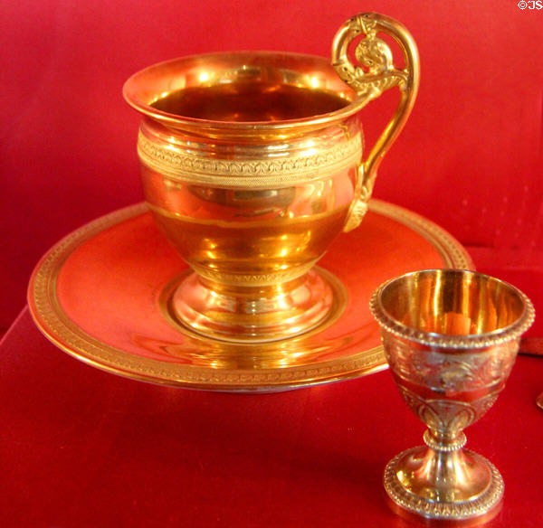 Cups & saucers (c1810) by Deroche of Paris & gilded silver egg cup (early 19thC) at Louvre Museum. Paris, France.