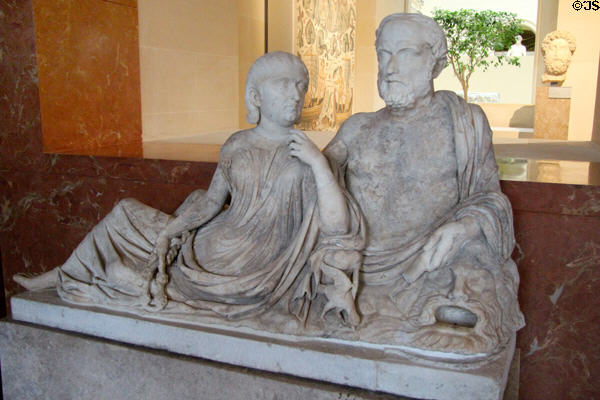 Marble carved couple on statue on fountain section (c235 CE) from Italy which mimicked sarcophagus cover at Louvre Museum. Paris, France.