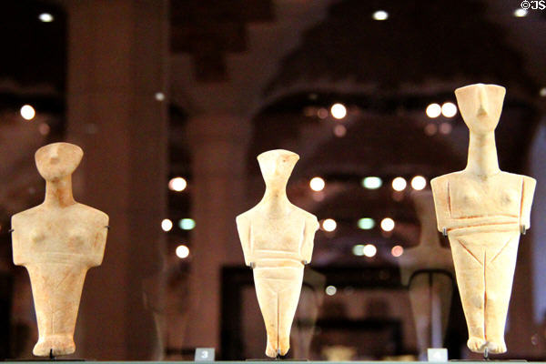 Three Cycladian marble female statuettes (c2750-2300 BCE) (Spedos type) at Louvre Museum. Paris, France.